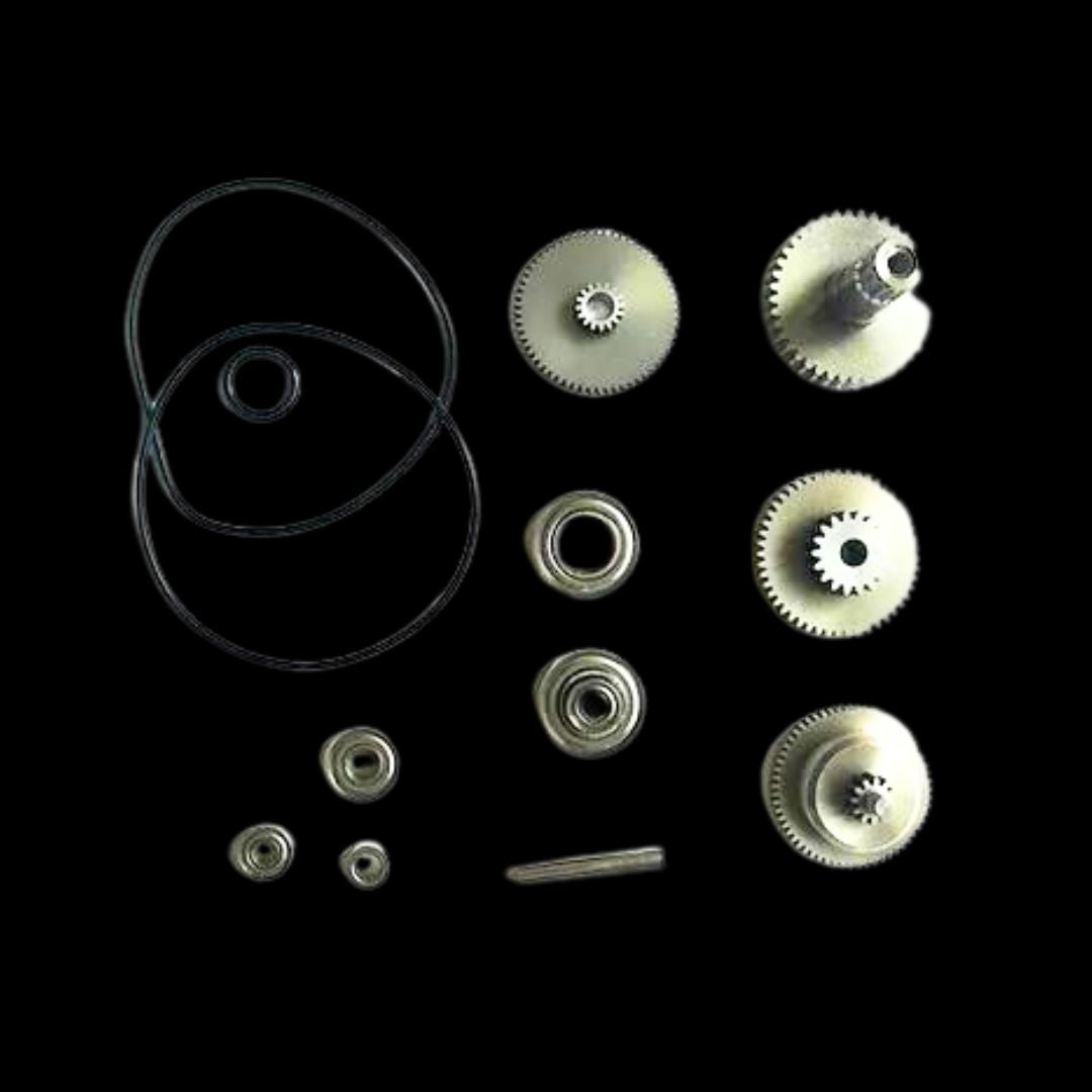 A collection of various gears, bearings, and seals, likely made of metal, displayed against a black background.