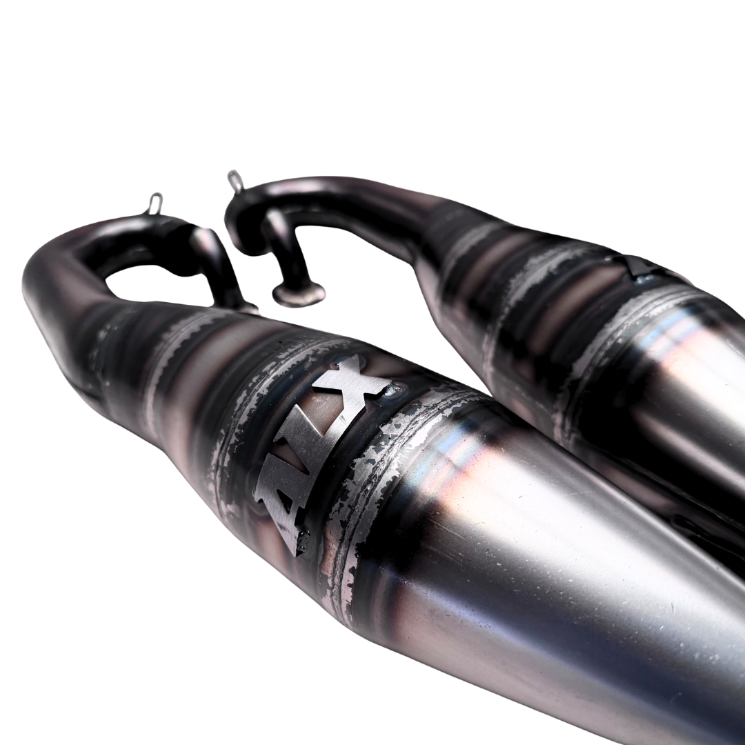 Close-up of an RC car exhaust system with 'ALX' branding on a white background