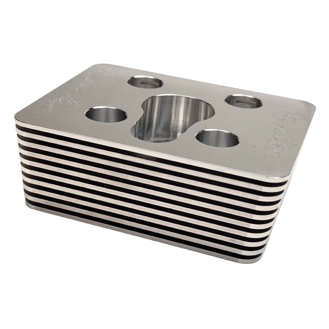 Metallic block with circular holes on a white background