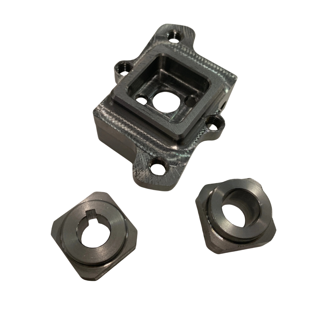 Three metal clutch components on a white background