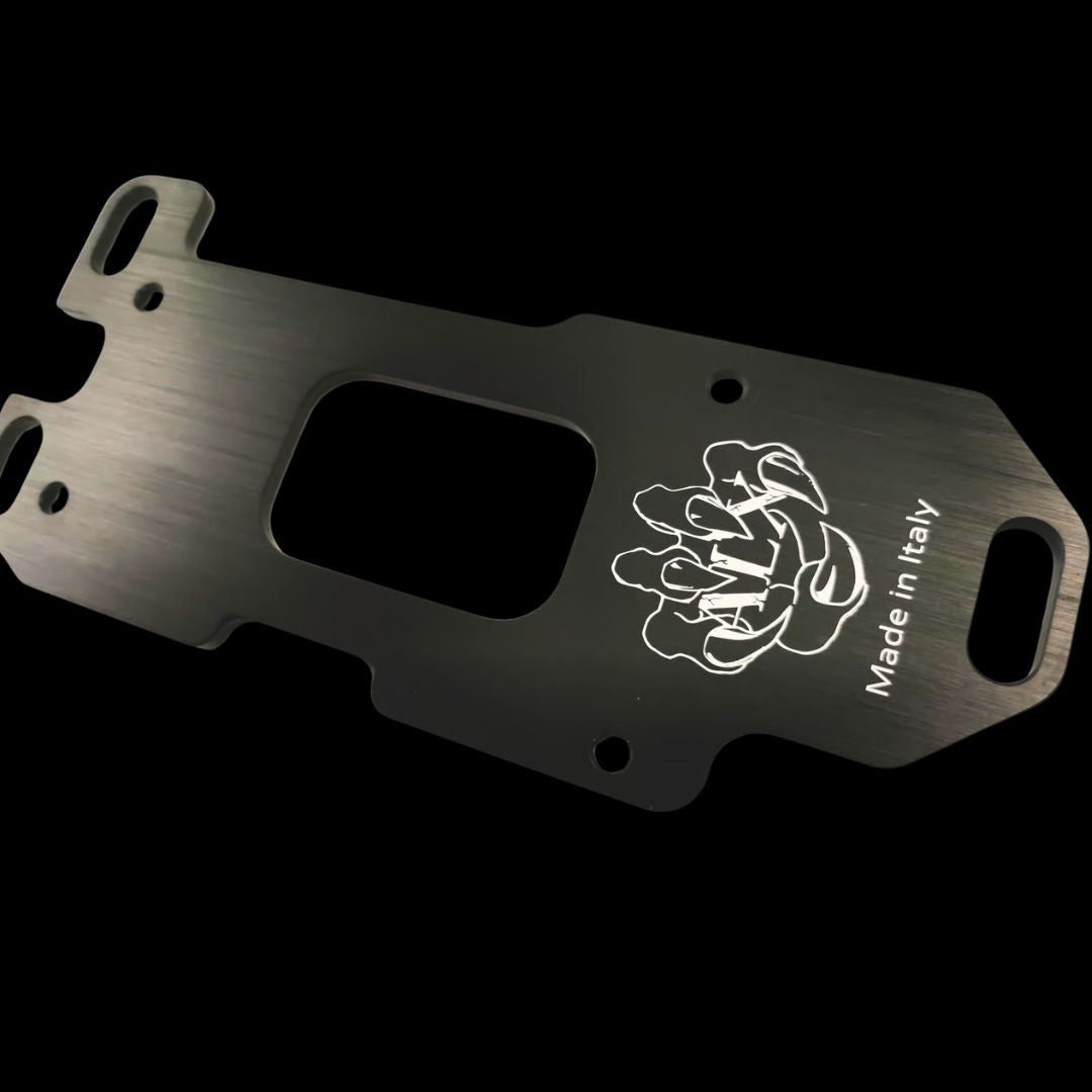 Metal engine mounting plate with brand logo and 'Made in Italy' text on a black background