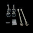 A set of metal dogbone kit parts for a remote control toy, including shafts and pins, displayed on a clear surface.