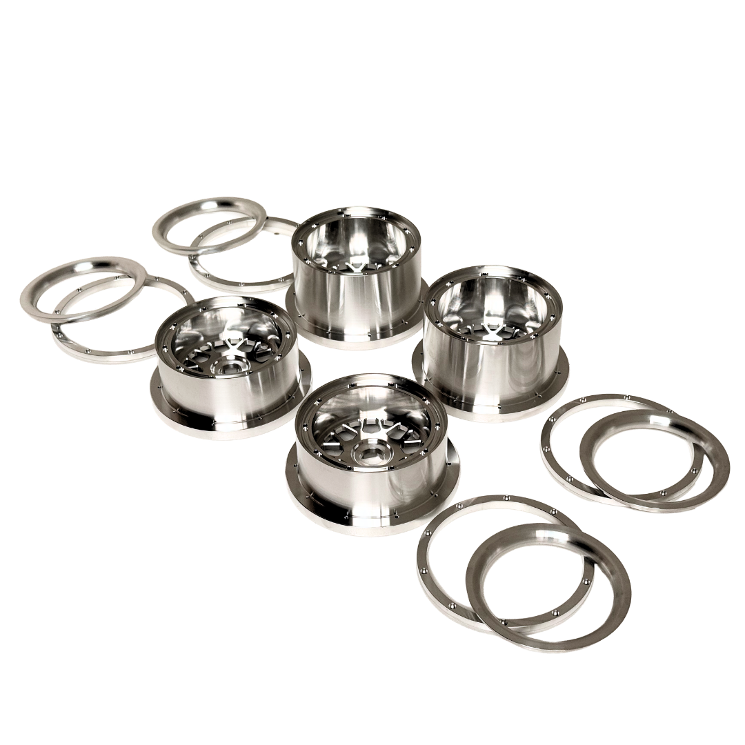 Beast RC Baja 5B complete billet wheel set with 8-piece beadlocks, angled view from an alternate angle showing the narrower front wheels with hidden-bolt beadlock rings