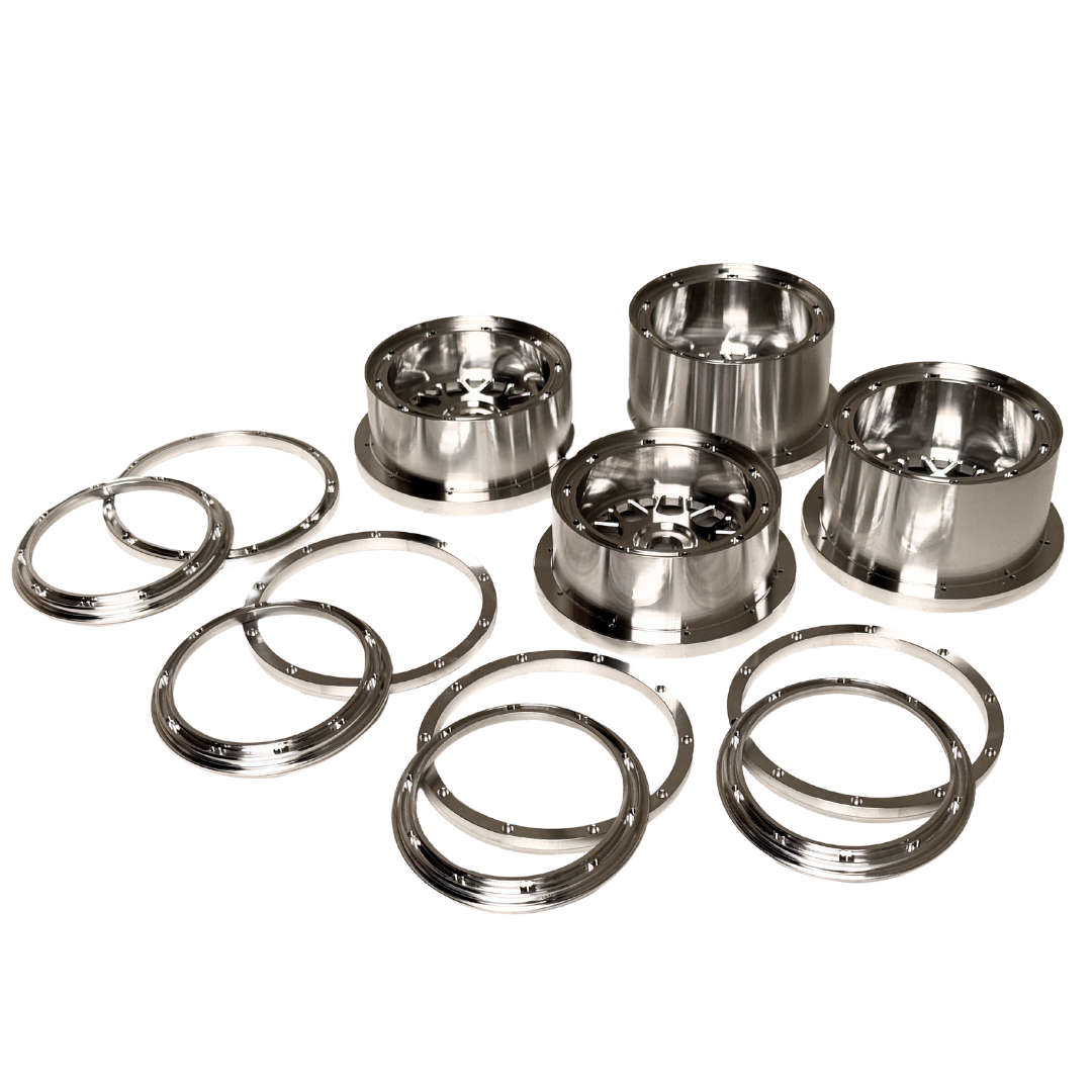 Beast RC Baja 5B complete billet wheel set with 8-piece beadlocks, angled view showing the narrower front wheels with hidden-bolt beadlock rings