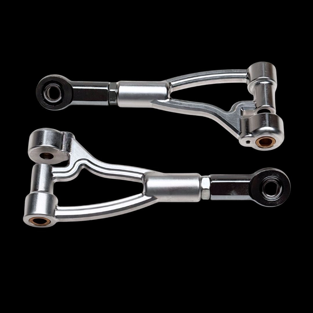 Two metallic control arms on a black background