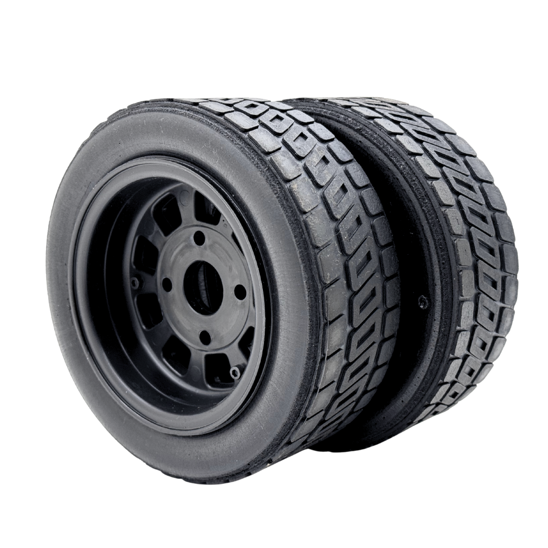 Black tire with tread pattern on a white background