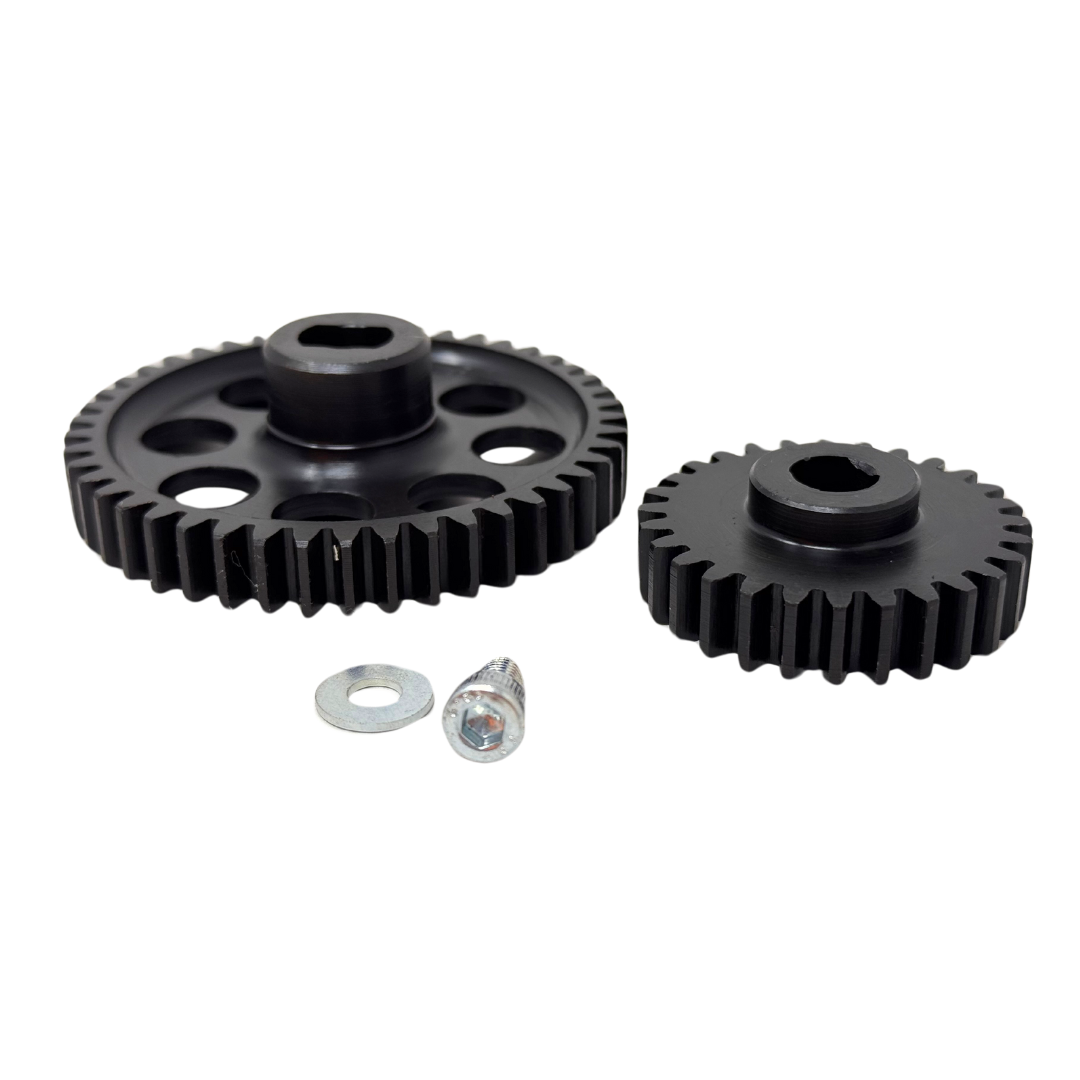 Two black gears and two small metal washers on a white background