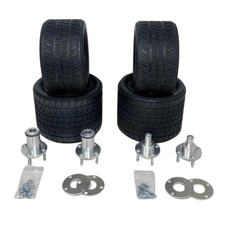 Set of four black tires and multiple metal components on a white background