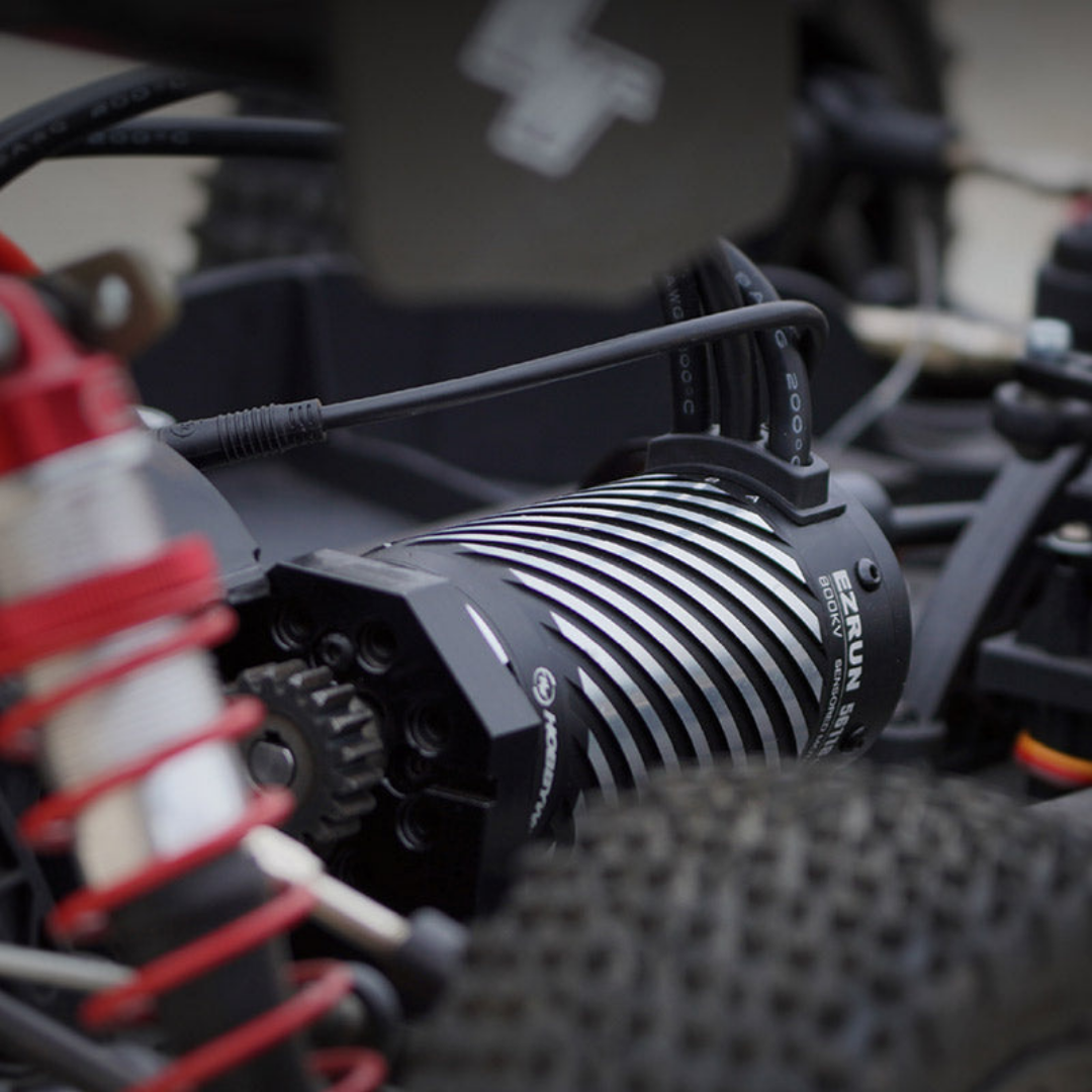 Close-up of a remote control car's engine and suspension system.