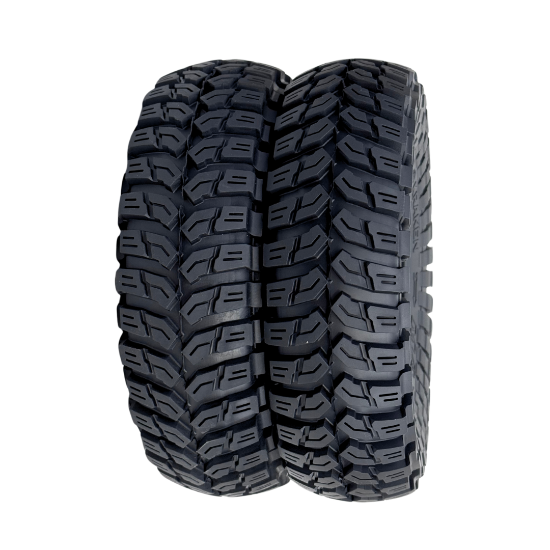 Tire with prominent tread pattern on a white background