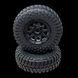 Two black off-road tires with tread patterns on a transparent background