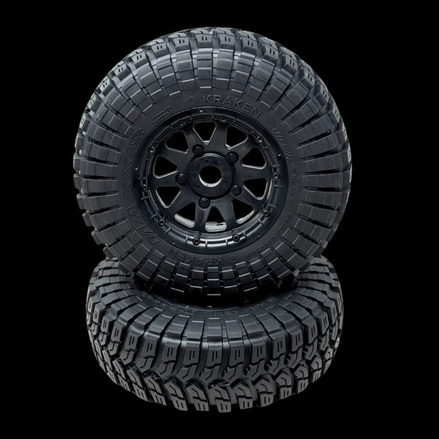 Two black off-road tires with tread patterns on a transparent background