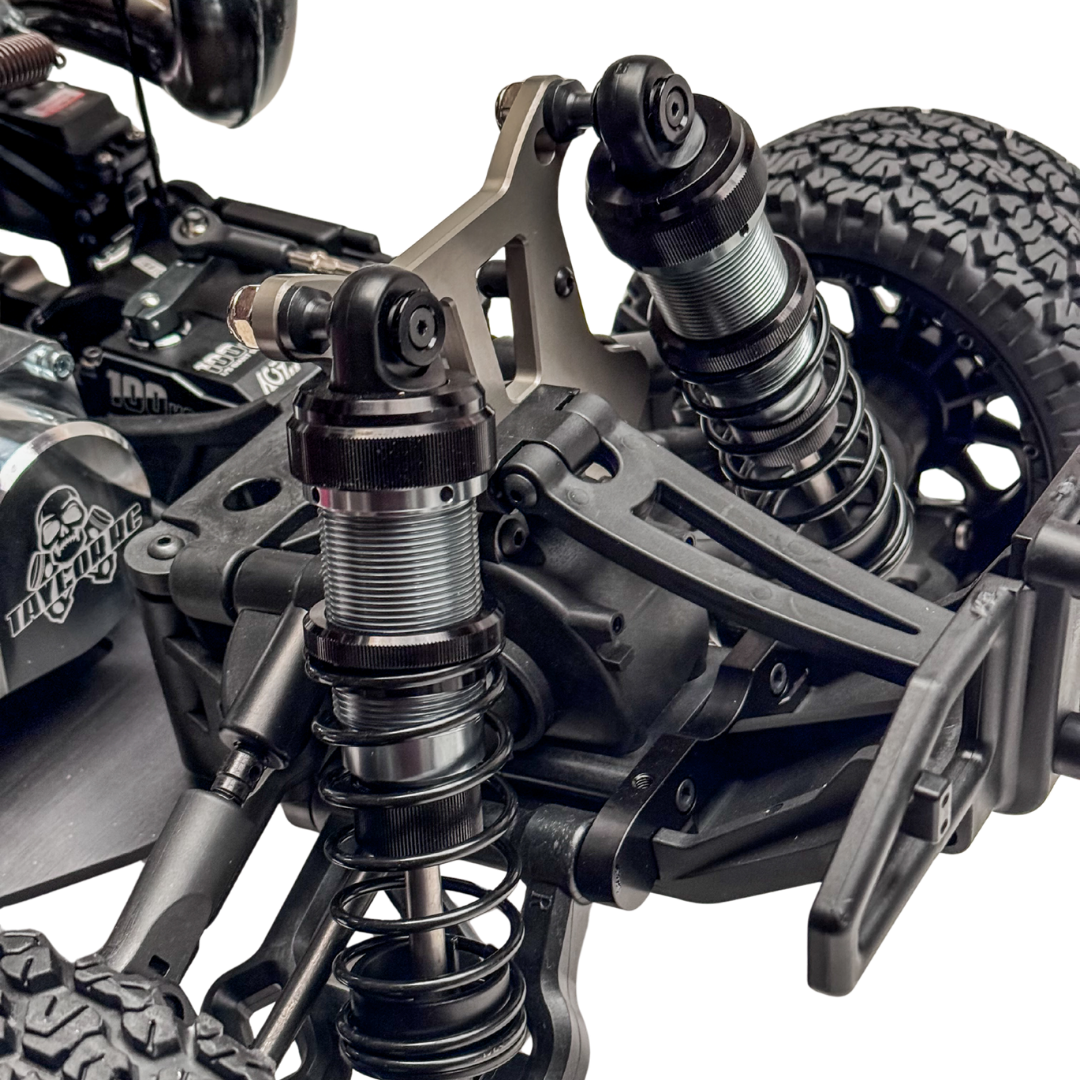 Close-up of a detailed model vehicle suspension system on a white background
