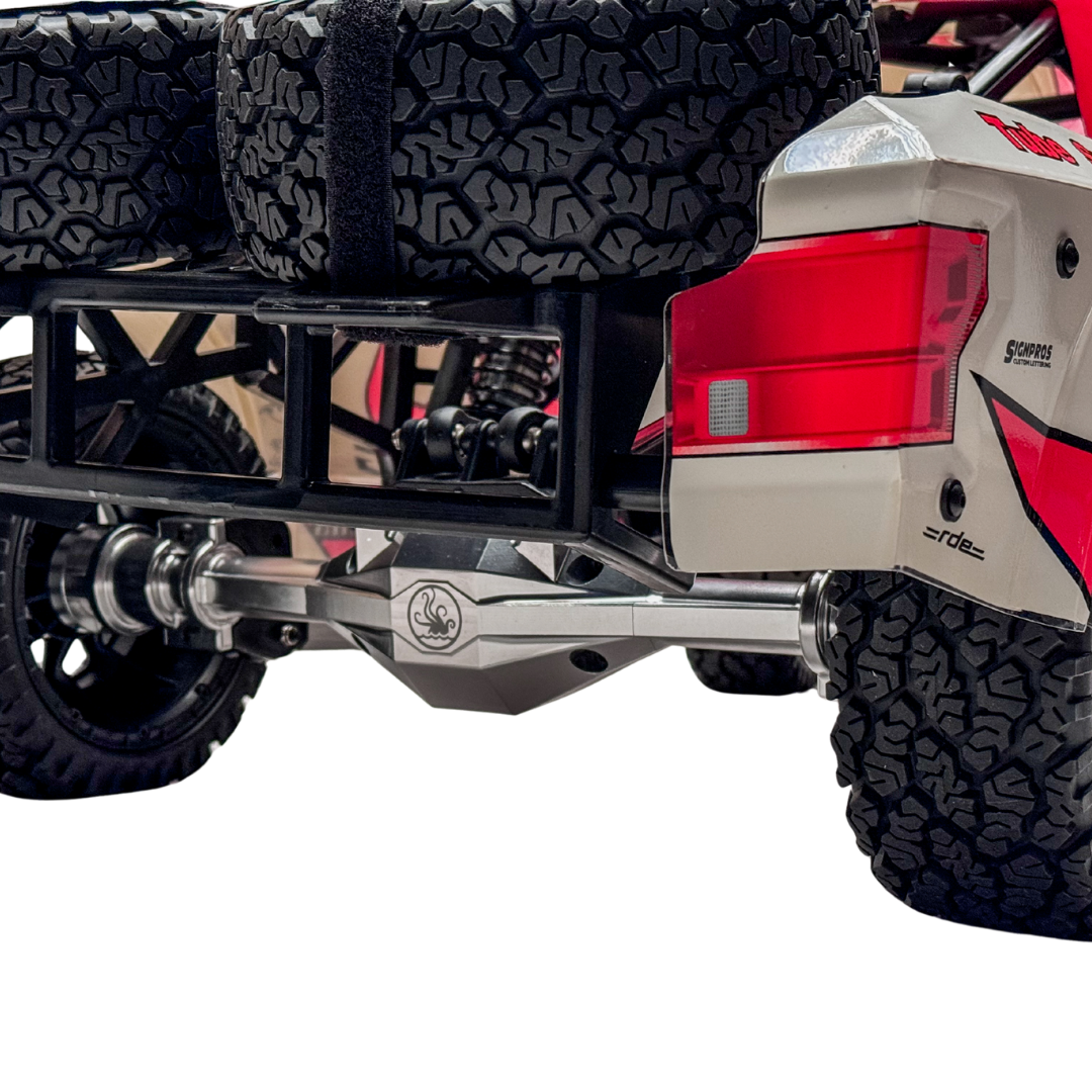 Close-up of an off-road vehicle's rear with visible suspension and tire tread.