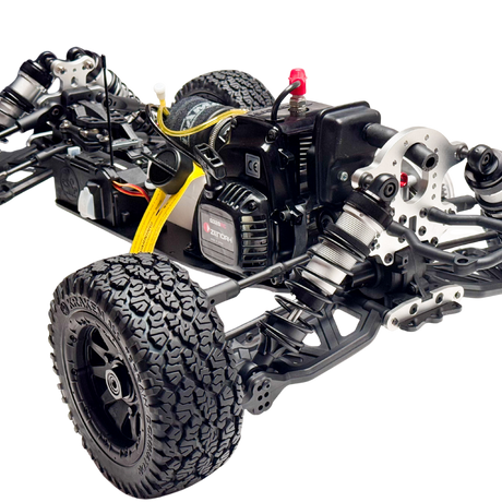 Close-up of a detailed model car chassis with visible components on a white background