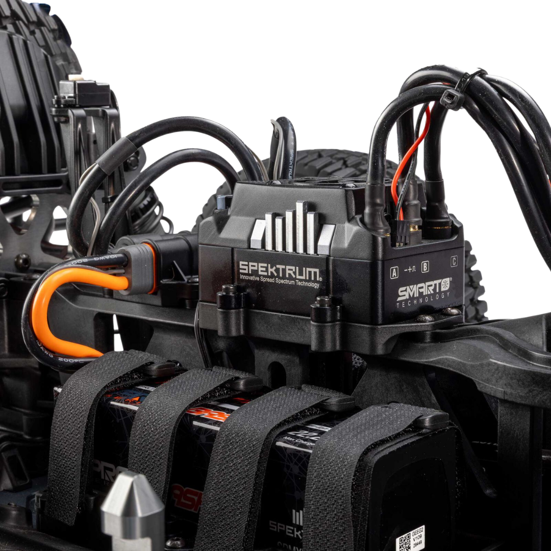 Spektrum electronic speed control unit on a model vehicle with visible branding.