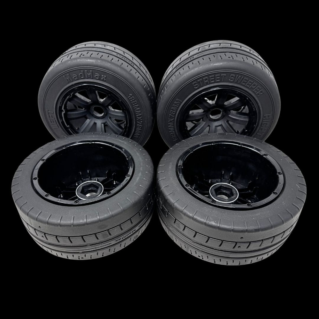 Four black wheels with visible branding on a transparent background