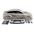 Clear plastic car body shell with black parts and accessories on a white background