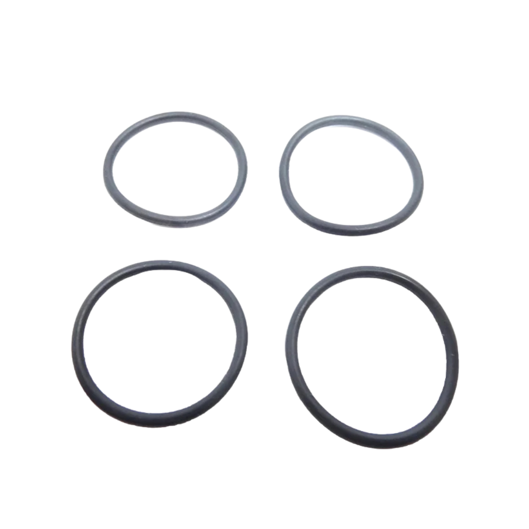 Four black rubber o-rings on a white background