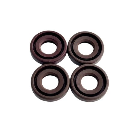 Four brown rubber washers on a white background