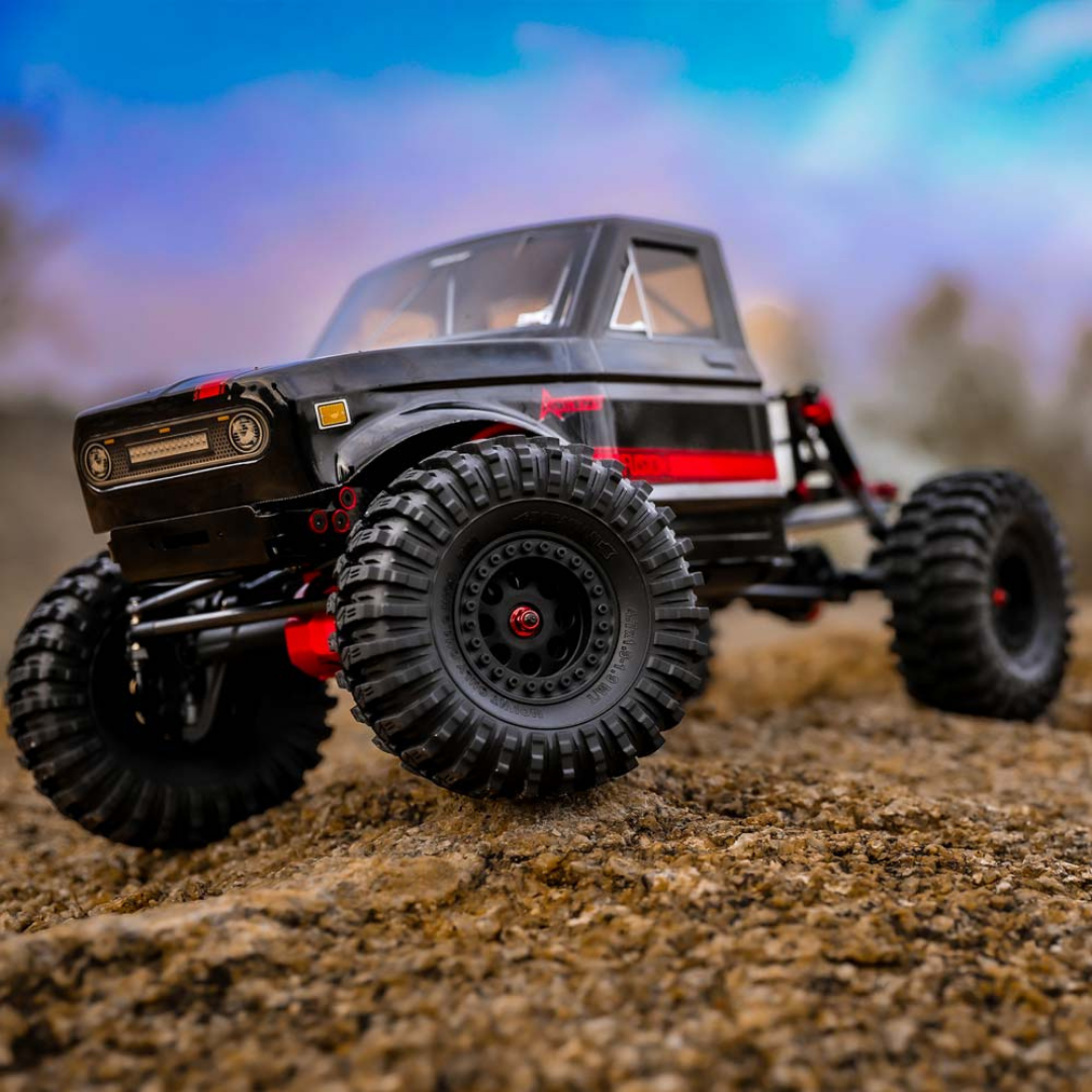 Model off-road vehicle on a dirt surface with a blurred background
