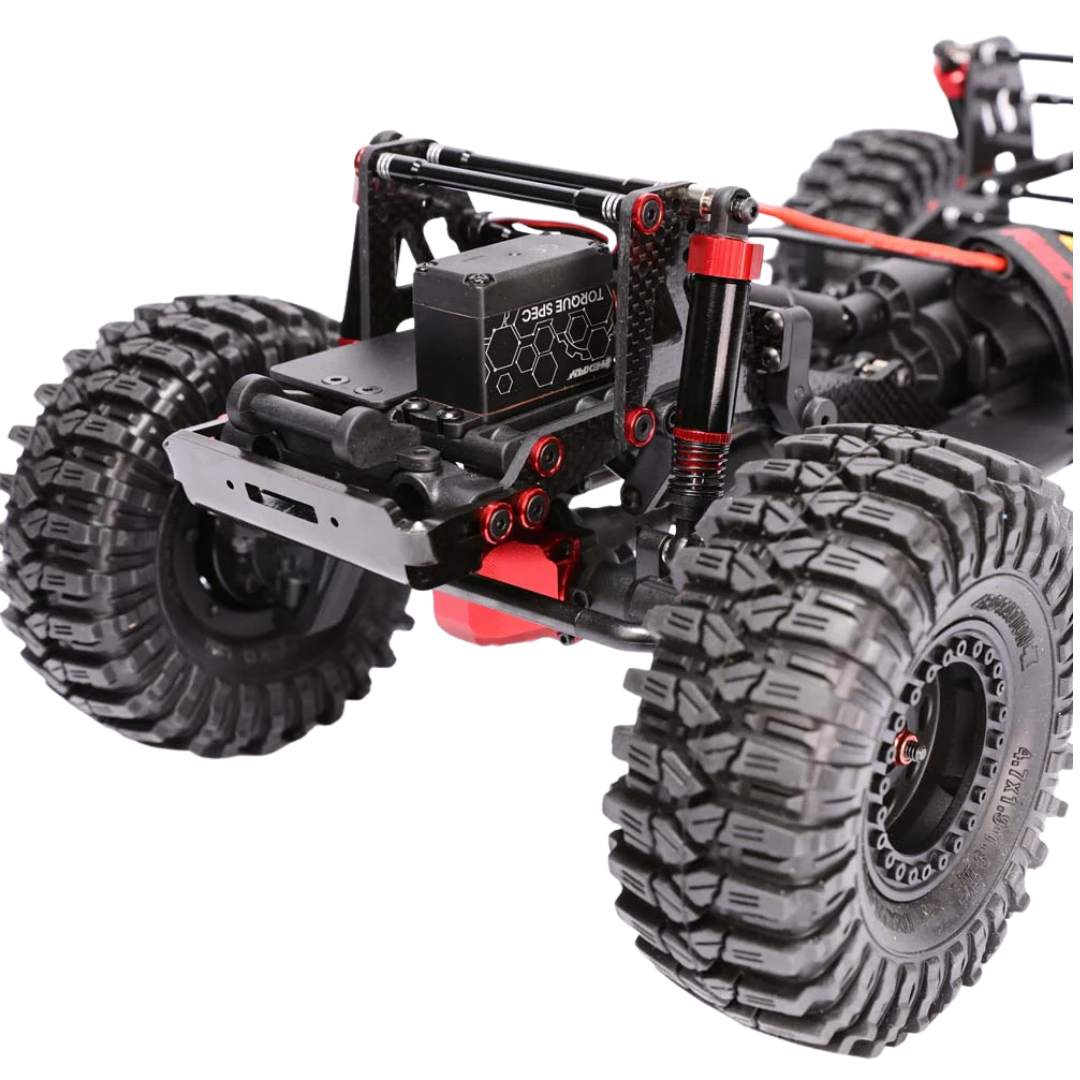 Close-up of a remote control monster truck chassis with large tires on a white background