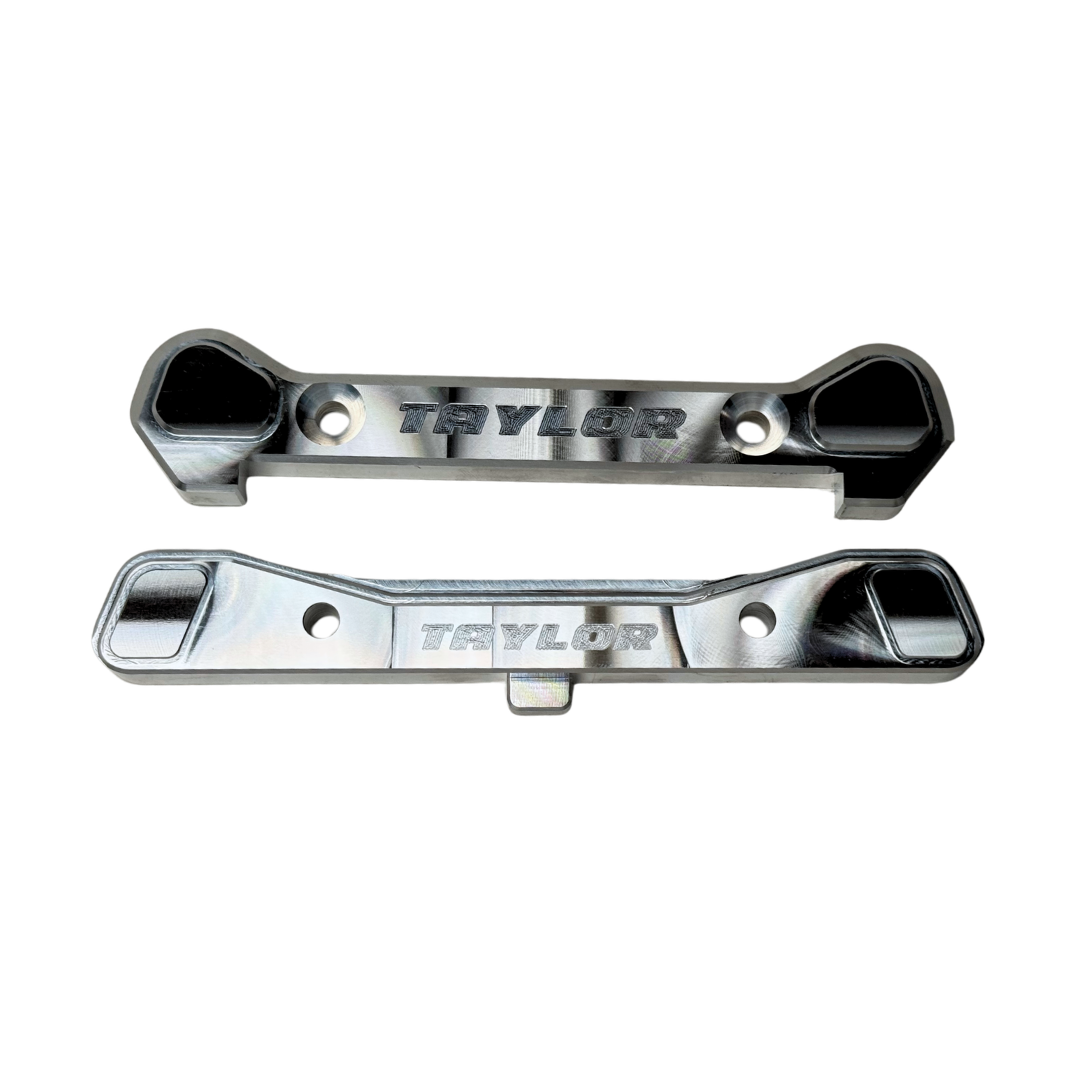 Taylor Losi 5T, 5IVE 2.0 and 5IVE-TG 3.0 raw silver billet 7075 rear hinge pin braces, top view showing the engraved Taylor logo and machined pockets