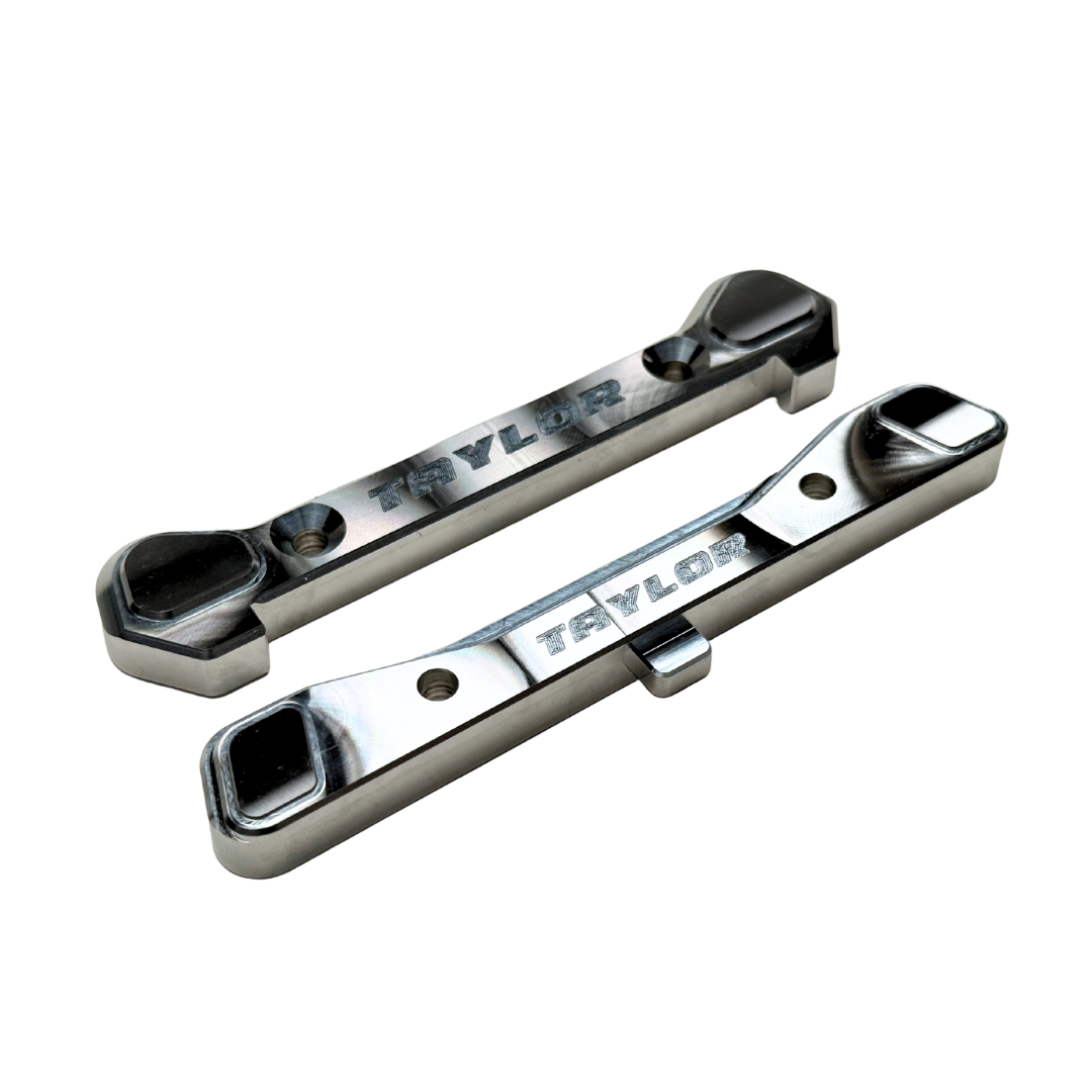 Taylor Losi 5T, 5IVE 2.0 and 5IVE-TG 3.0 raw silver billet 7075 rear hinge pin braces, pair showing the engraved Taylor logo and machined pockets