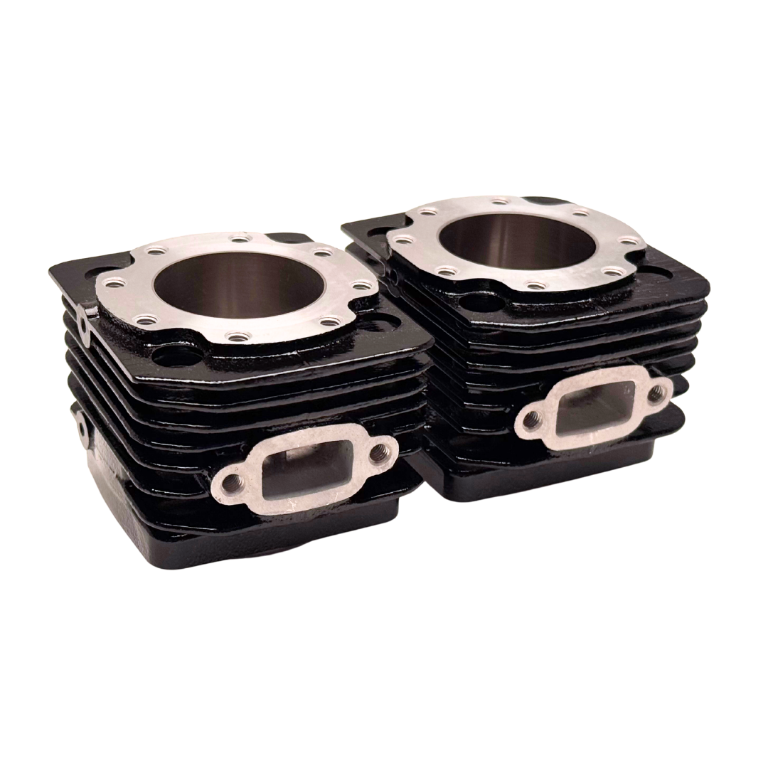 Stack of black engine cylinder heads on a white background