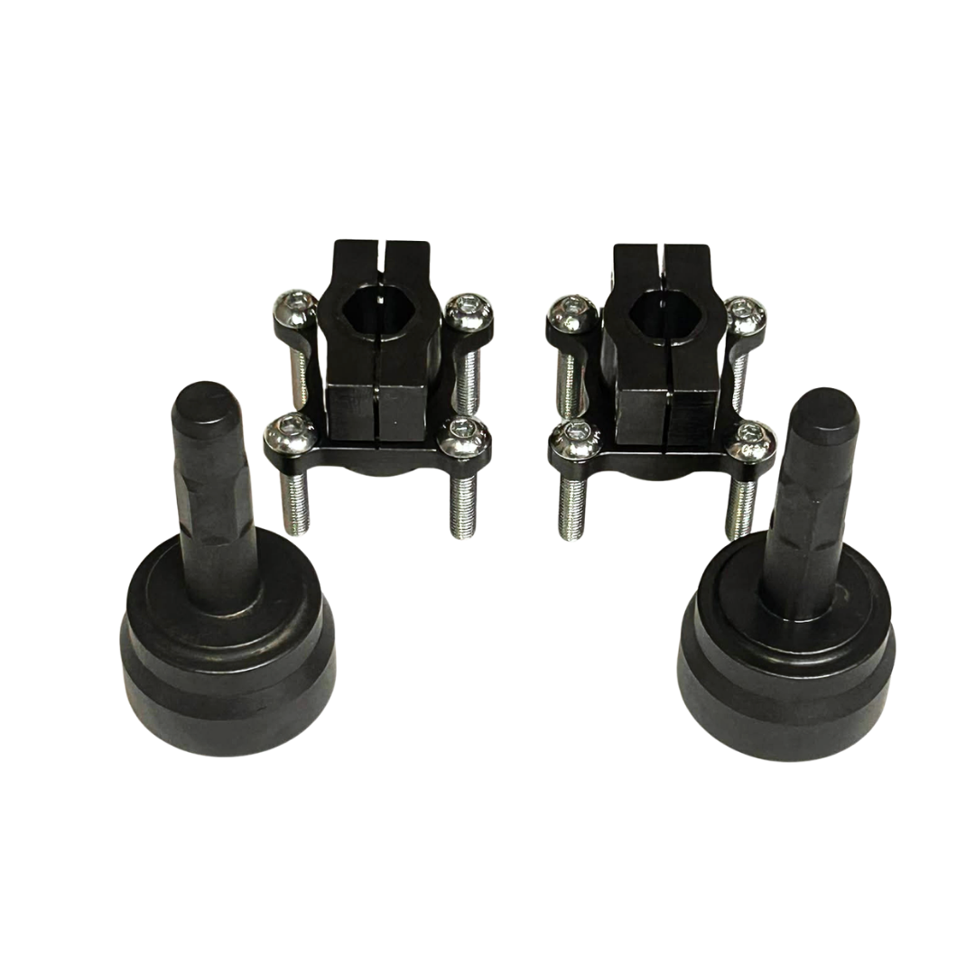 A set of four black metal mechanical components, including two central mounting brackets with silver screws