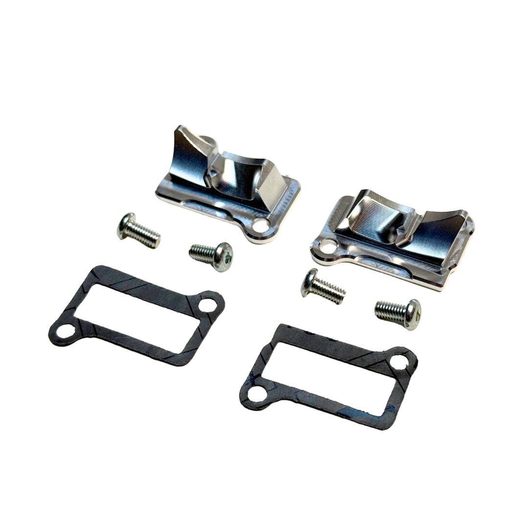 Taylor RC billet CNC ported Zenoah G320 & Fujiwara 350RC transfer covers in raw silver, angled view of the ported face with gaskets and mounting screws
