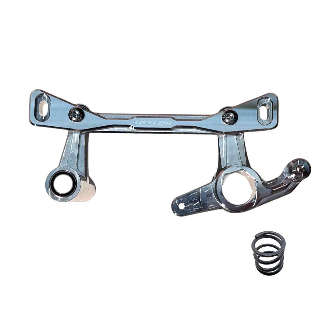 A silver metal suspension link assembly with a black coil spring, shown on a plain white background. The brand name 'TAYLOR' is embossed on the center bar.