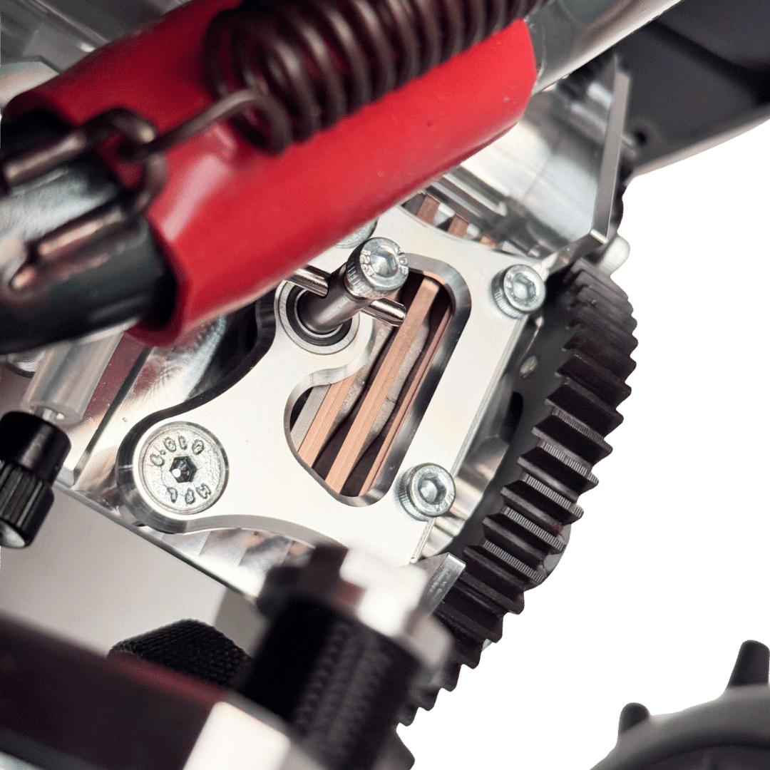 Close-up of a mechanical component with gears and a red tool on a green background