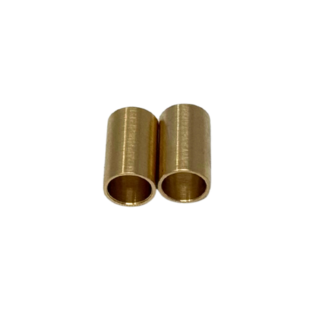Two brass cylindrical bushings on a white background