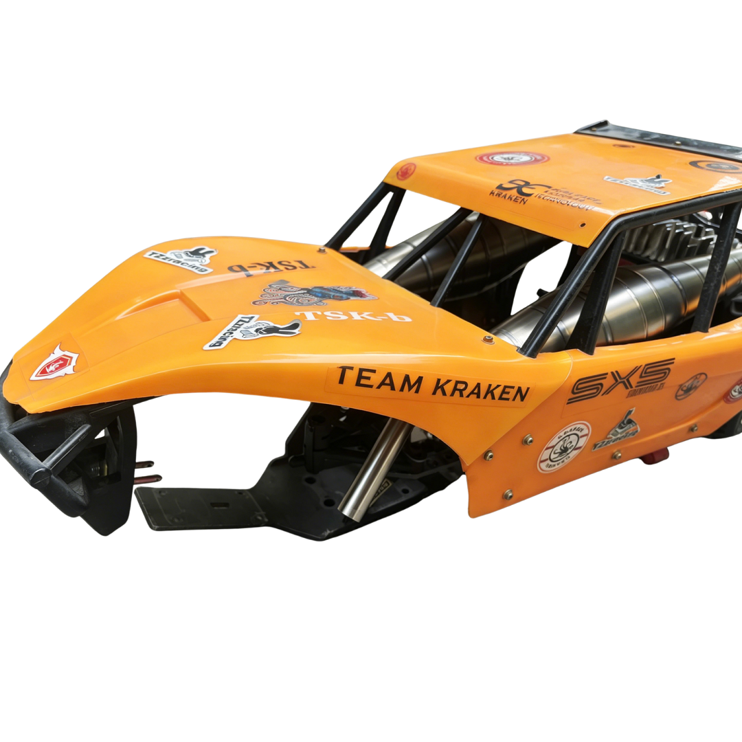 Orange off-road vehicle chassis with 'Team Kraken' branding on a white background