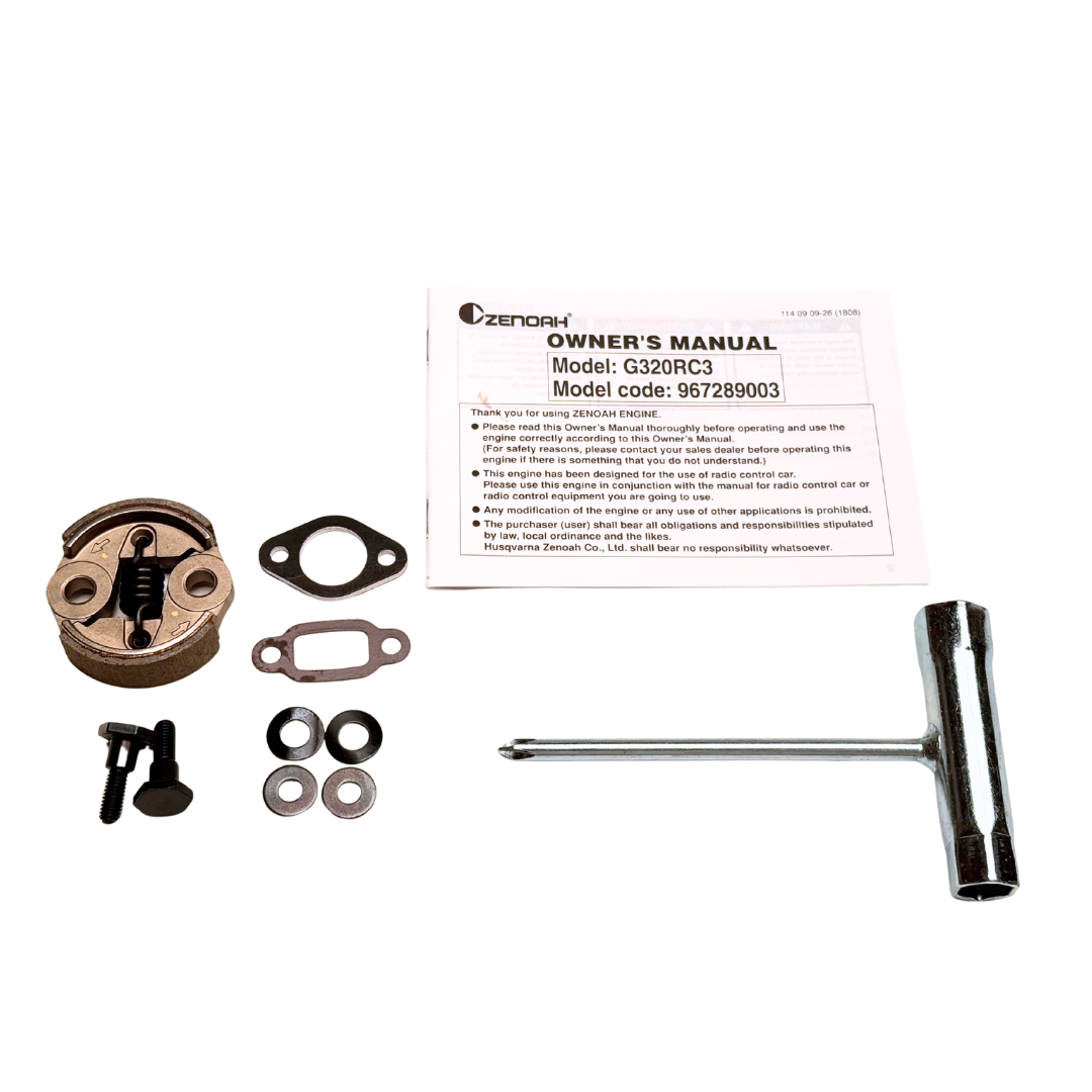 Engine parts and Zenoah owner's manual on a white background