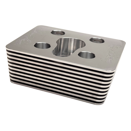 Metallic block with circular holes on a white background