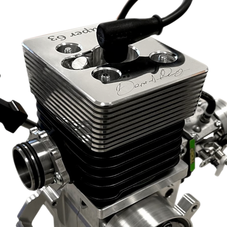 Close-up of a silver engine block with visible branding on a white background