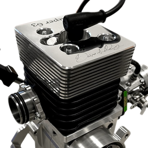 Close-up of a silver engine block with visible branding on a white background