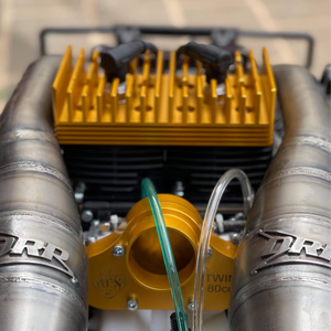 Close-up of ALX Twin 80cc gold engine with DRP exhaust pipes installed in HPI Baja