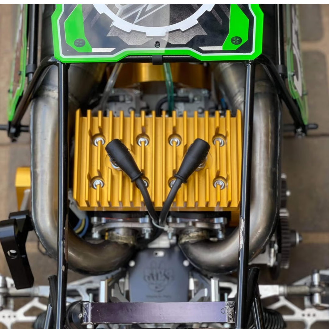 Close-up of ALX Twin 80cc gold heat sink and dual exhaust installed in HPI Baja