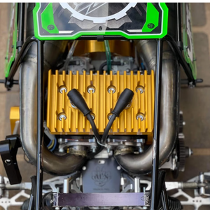 Close-up of ALX Twin 80cc gold heat sink and dual exhaust installed in HPI Baja