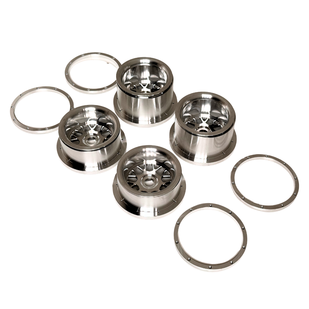 Beast RC Baja 5B complete billet wheel set with 8-piece beadlocks, top-down view showing the narrower front wheels with hidden-bolt beadlock rings