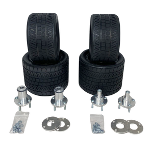 Set of four black tires and multiple metal components on a white background