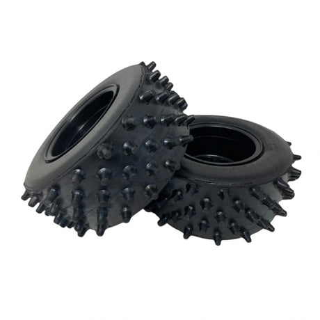Two spiked tires on a transparent background