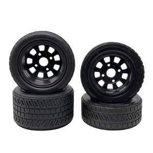 Four black wheels with tread patterns on a white background