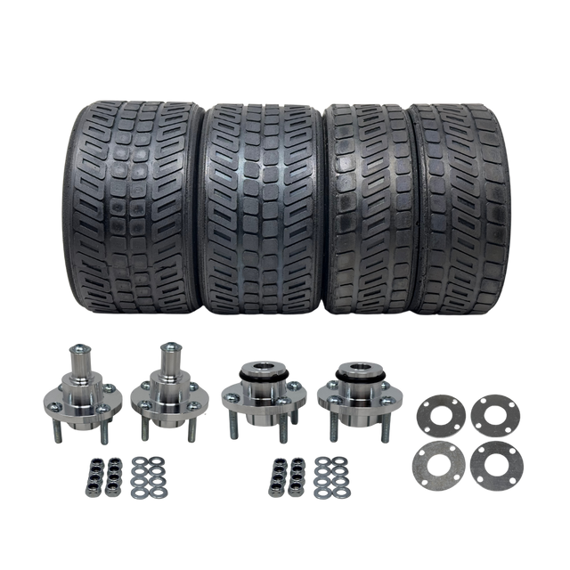 Set of four tires and their corresponding metal components on a white background