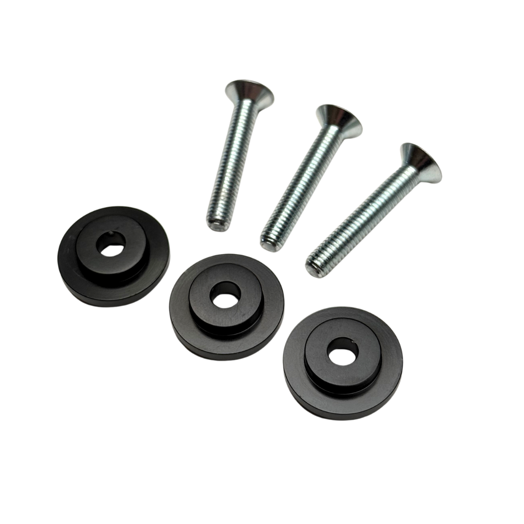 Set of black rubber washers and metal screws on a white background