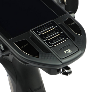 Close-up of a black electronic device with control buttons on a white background