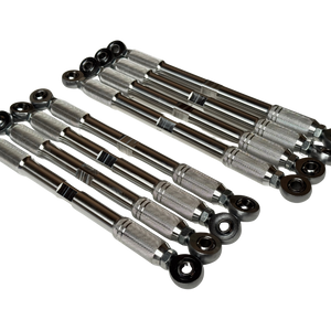 A set of metallic steering knuckle bushings with black rubber spherical ends, arranged diagonally on a plain white background.